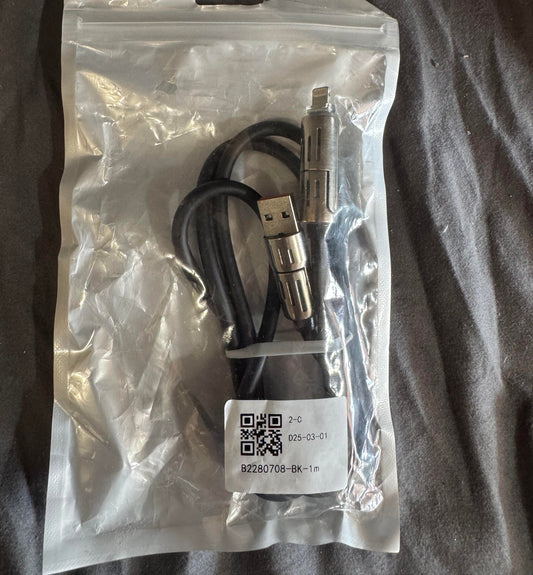 USB cable in a clear plastic bag on a dark fabric background