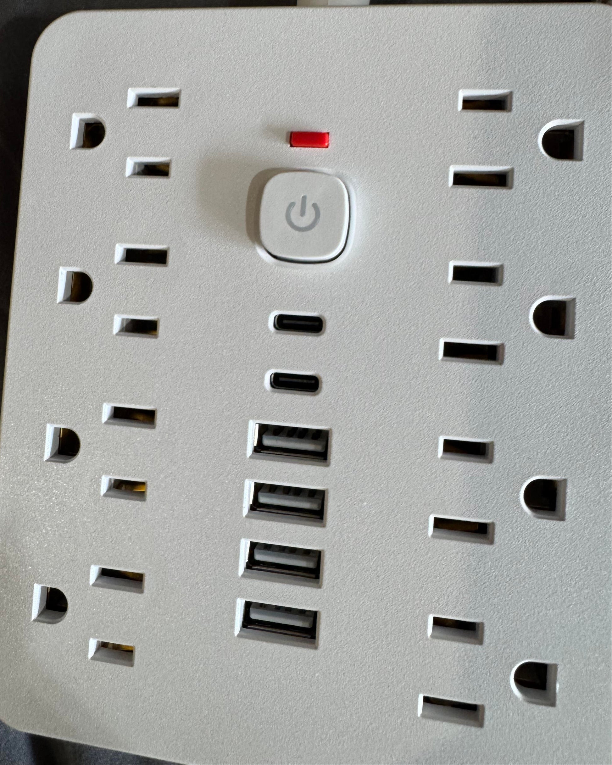 Power strip with multiple outlets and USB ports on a dark background